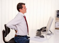 bigstock-young-man-in-office-with-compu-29935619