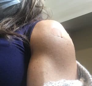 Blog author's left shoulder with bandaid from vaccination injection.